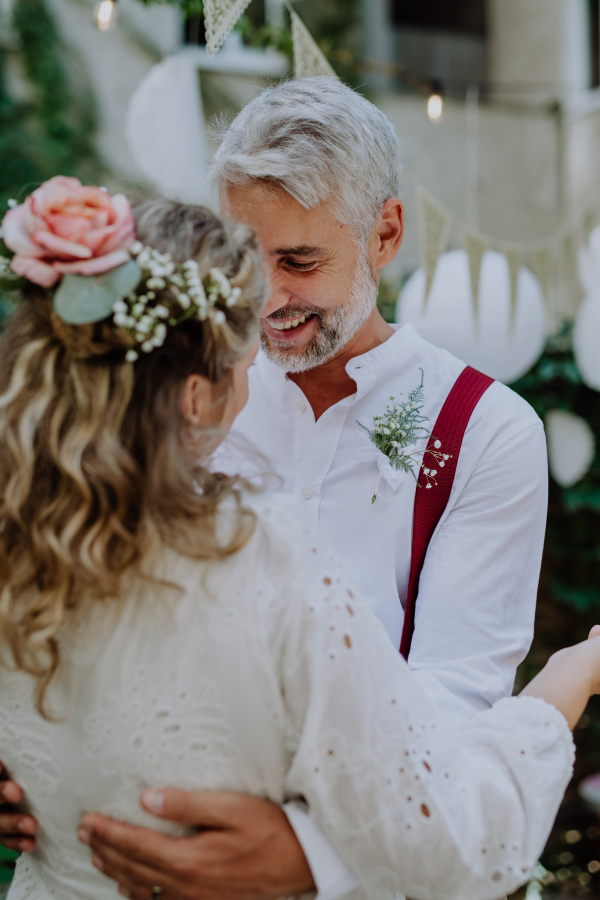 Mature bride and groom dancing at their outdoor wedding.