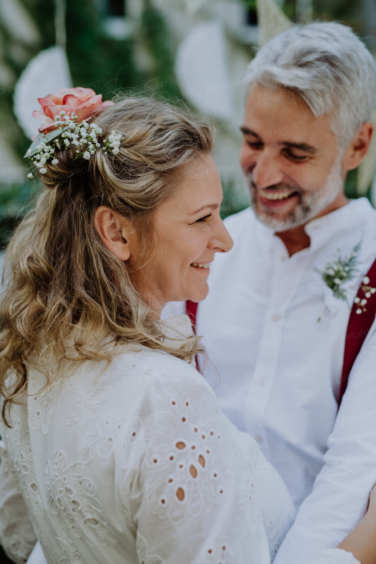 Close-up of bride and groom dancing at their outdoor wedding.