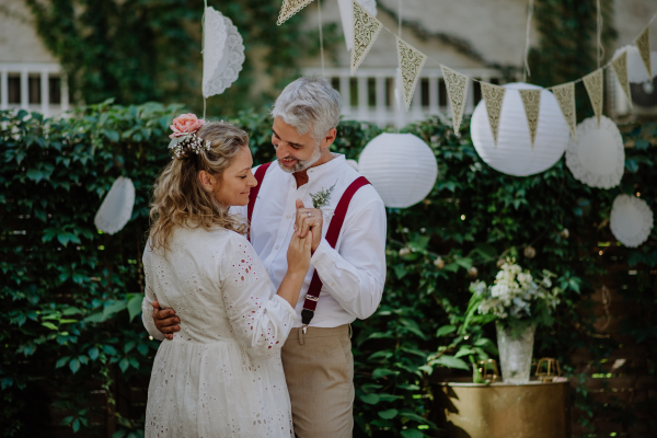 Close-up of bride and groom dancing at their outdoor wedding.