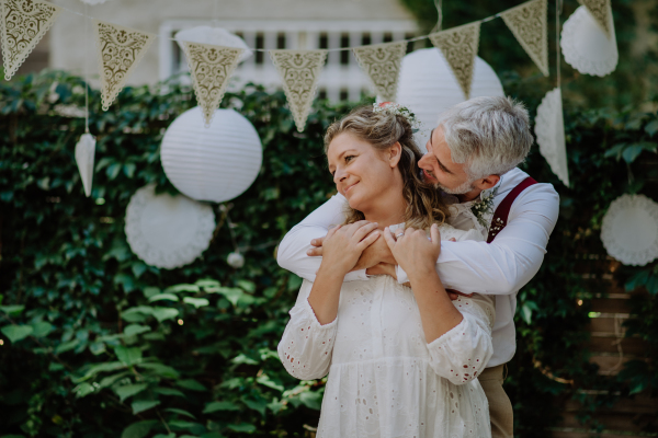 Close-up of bride and groom dancing at their outdoor wedding.