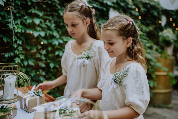 Little girls at an outdoor wedding garden party.