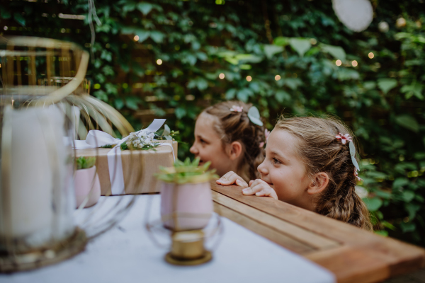 Little girls at an outdoor wedding garden party.