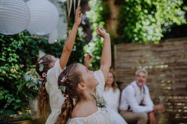 Little girl having fun at an outdoor wedding party.