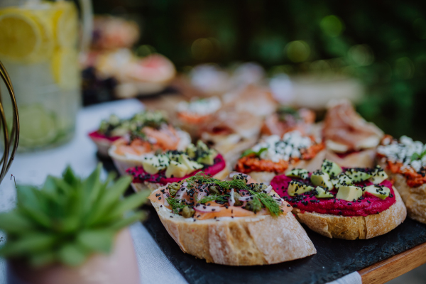 A dessert buffet at small wedding reception outside in the backyard.