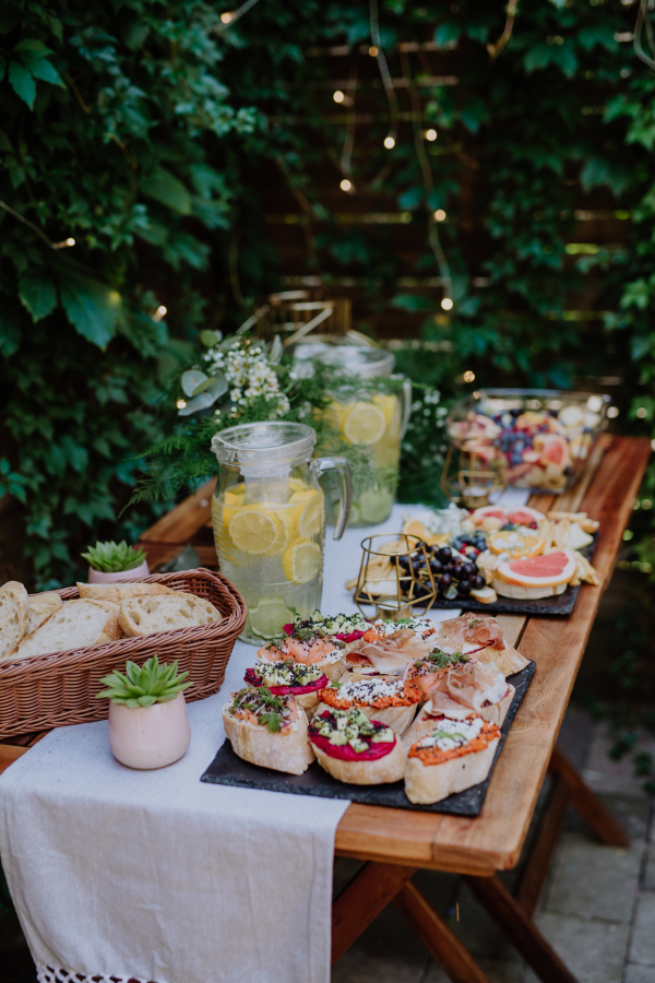 A dessert buffet at small wedding reception outside in the backyard.