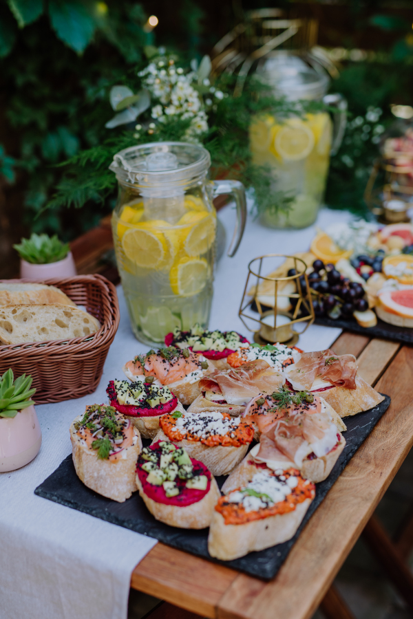 A dessert buffet at small wedding reception outside in the backyard.