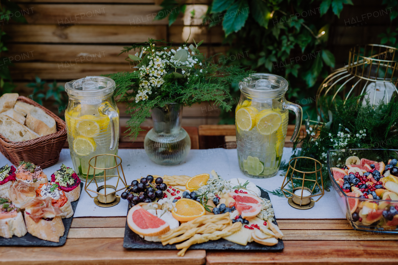 Close-up of a dessert buffet at small wedding reception outside in the backyard.