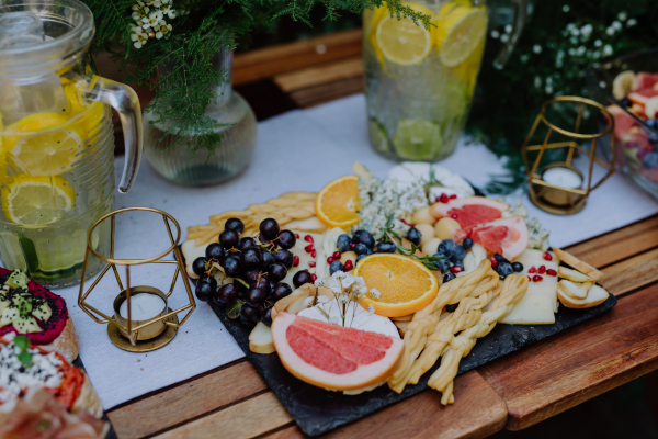 Close-up of a dessert buffet at small wedding reception outside in the backyard.