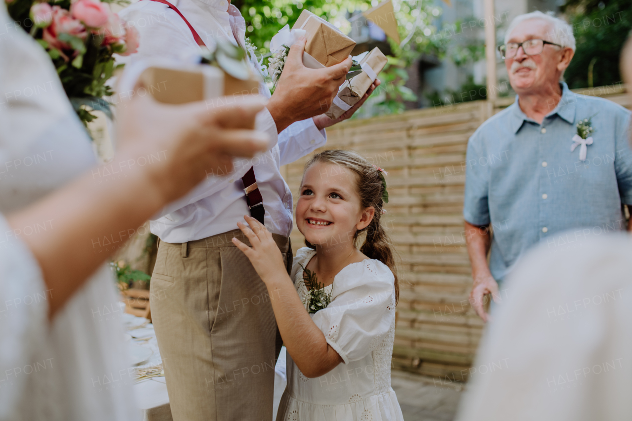 Multigenerational family at an outdoor wedding party.