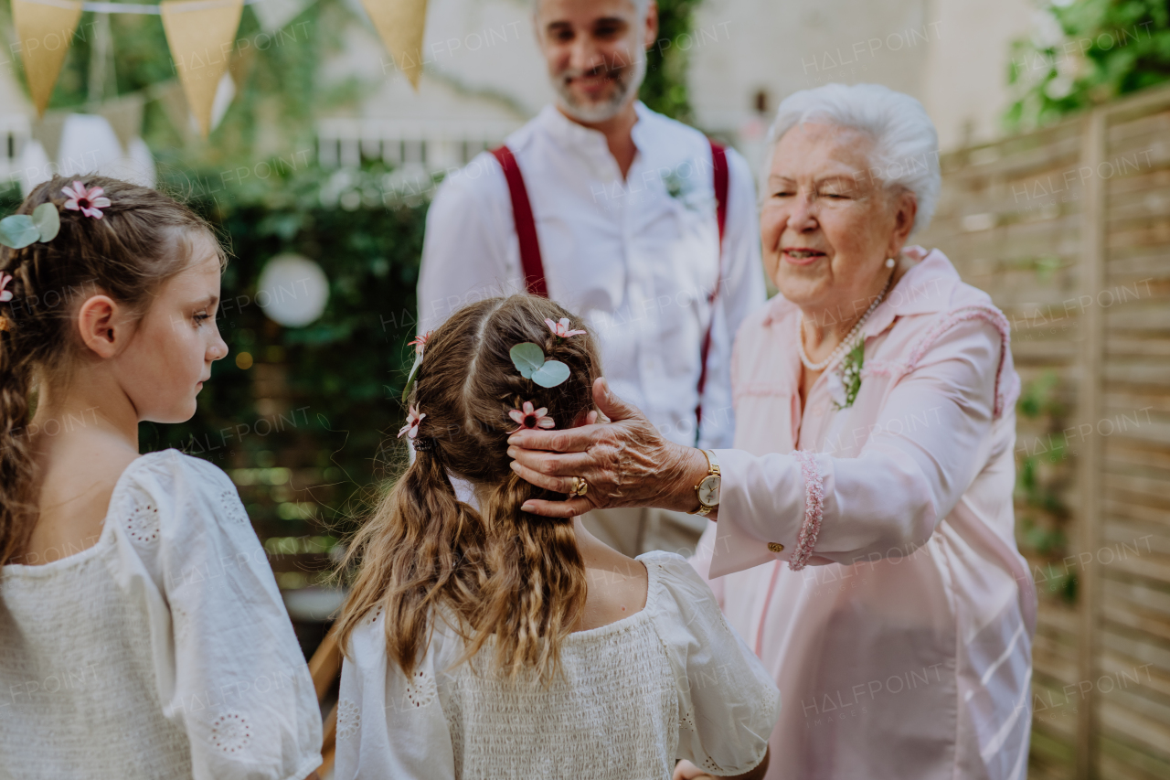 Multigenerational family at an outdoor wedding party.