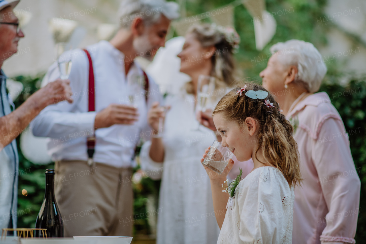 Multigenerational family at an outdoor wedding party.