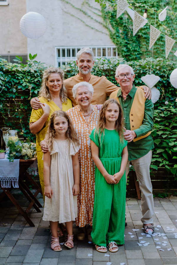 A multi-generation family on outdoor summer garden party, celebrating birthday