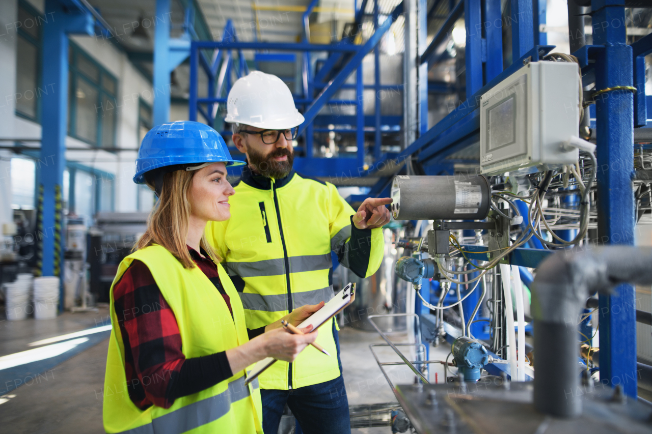 Female engineering manager and mechanic worker inside the factory