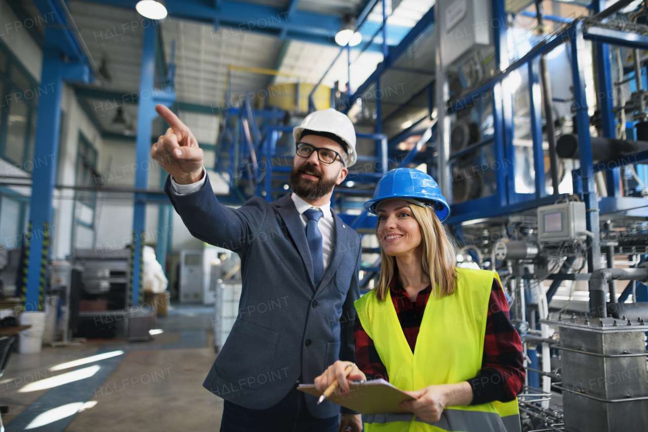 Female engineering manager and mechanic worker inside the factory