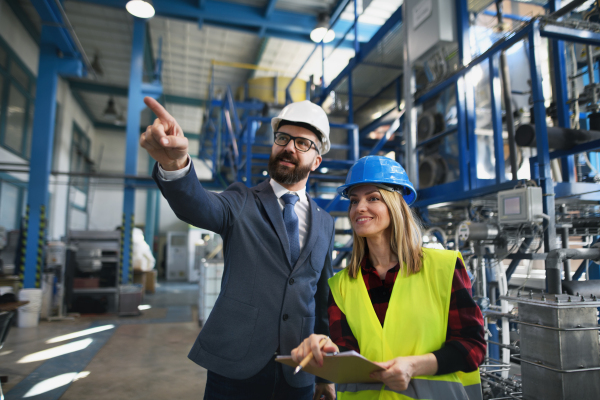 Female engineering manager and mechanic worker inside the factory