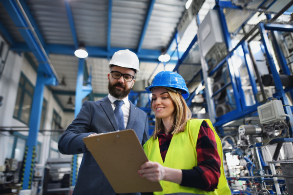 Female engineering manager and mechanic worker inside the factory