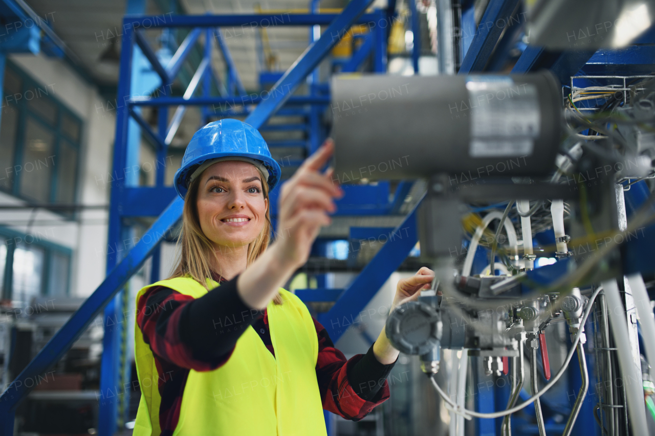 A portrait of female engineer working in industrial factory