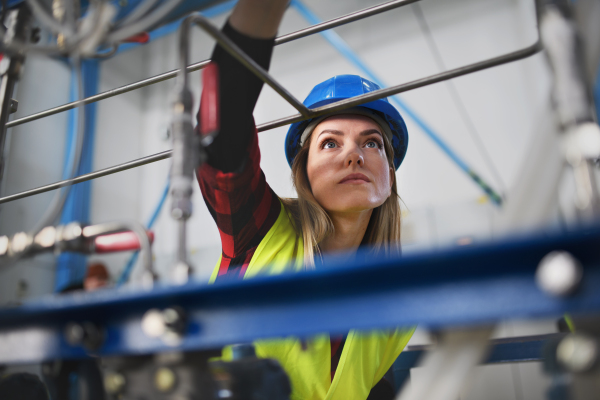 A portrait of female engineer working in industrial factory