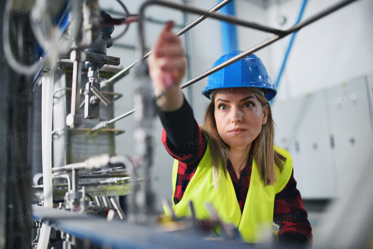 A portrait of female engineer working in industrial factory