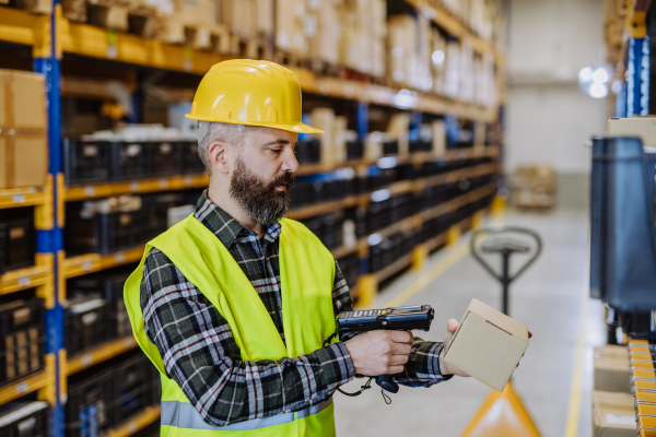 Warehouse worker checking up stuff in warehouse.