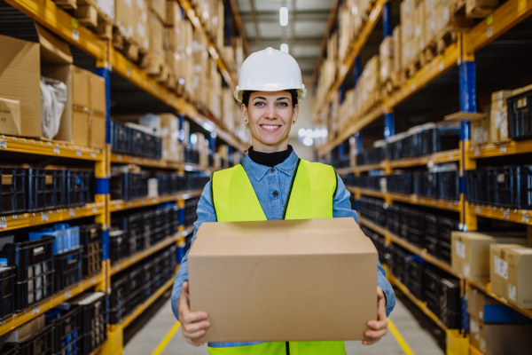 Warehouse female worker checking up stuff in warehouse.