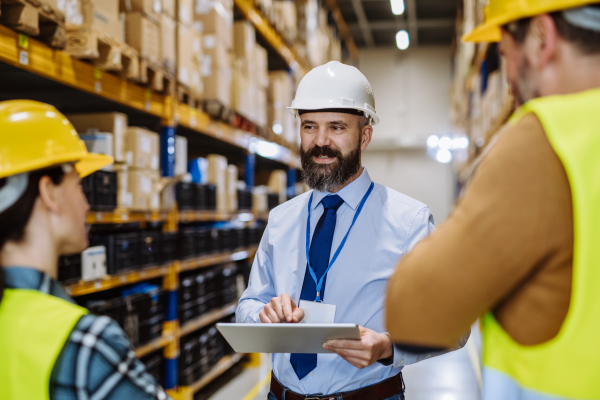 Manager explaining work to his employers in a warehouse.