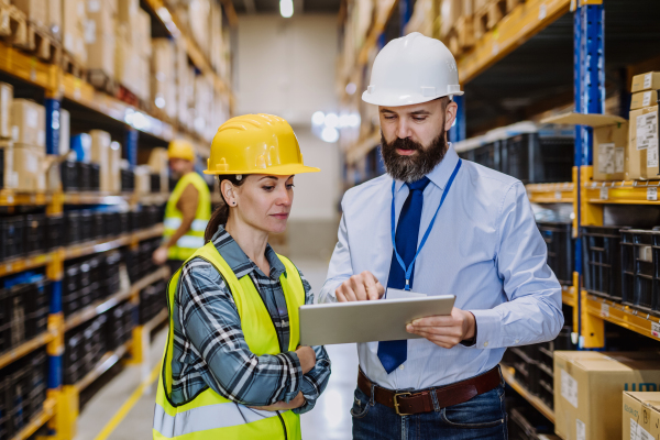 Manager explaining work to his employers in a warehouse.