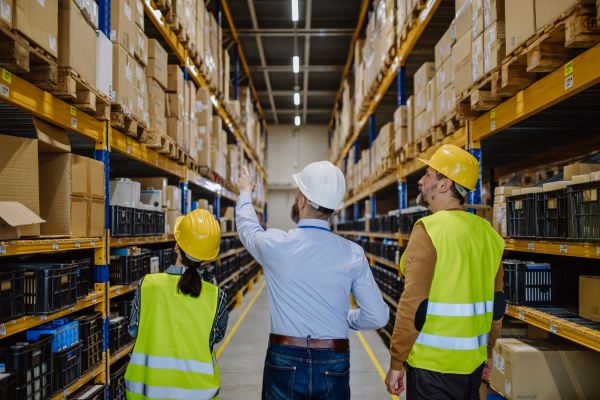 Manager explaining work to his employers in a warehouse.