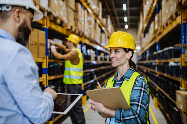 Manager explaining work to his employers in a warehouse.