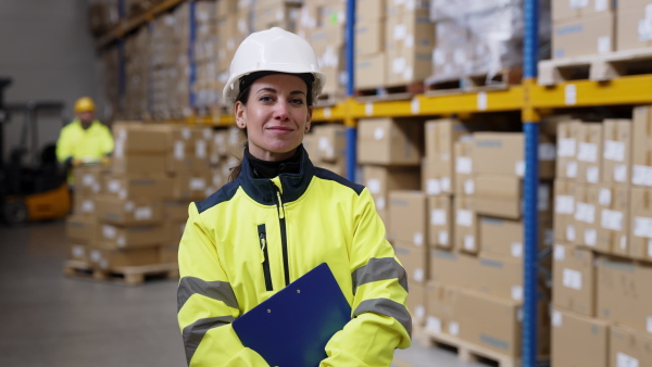 Video of a female warehouse worker or a supervisor looking at camera.