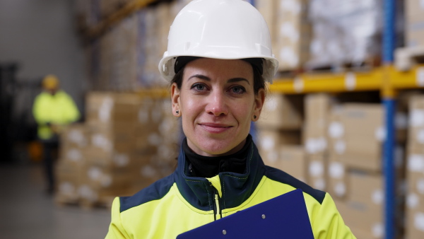 Video of a female warehouse worker or a supervisor looking at camera.