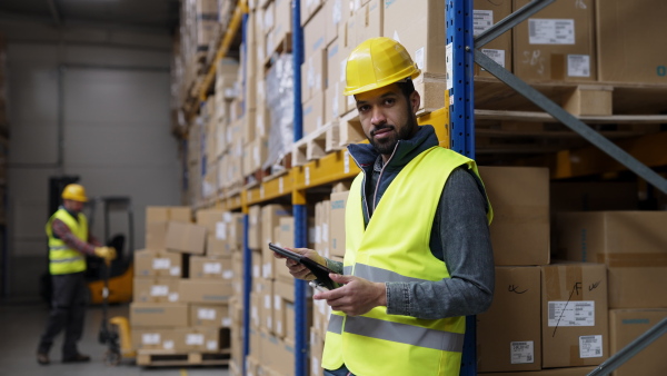 Video of a male warehouse worker or a supervisor looking at camera.