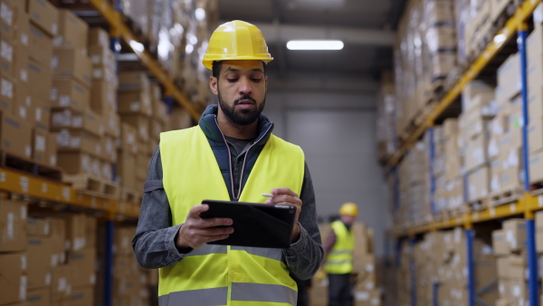 Warehouse male worker checking up stuff in warehouse.