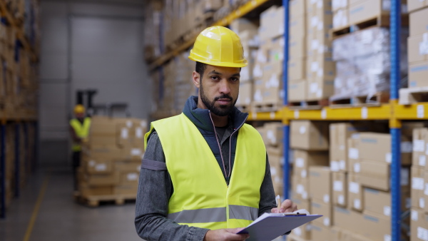 Video of a male warehouse worker or a supervisor looking at camera.