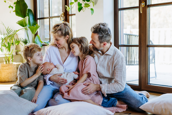 Portrait of nuclear family with newborn baby. Perfect moment. Strong family, bonding and parents' unconditional love for their children.