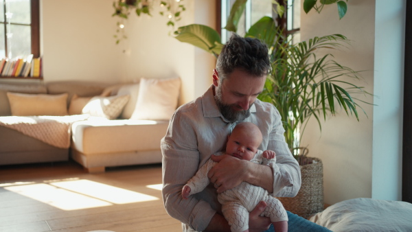 Father holding his newborn baby. Unconditional paternal love and Father's Day concept.