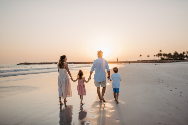 Happy family with little kids enjoying time at the sea in exotic country.