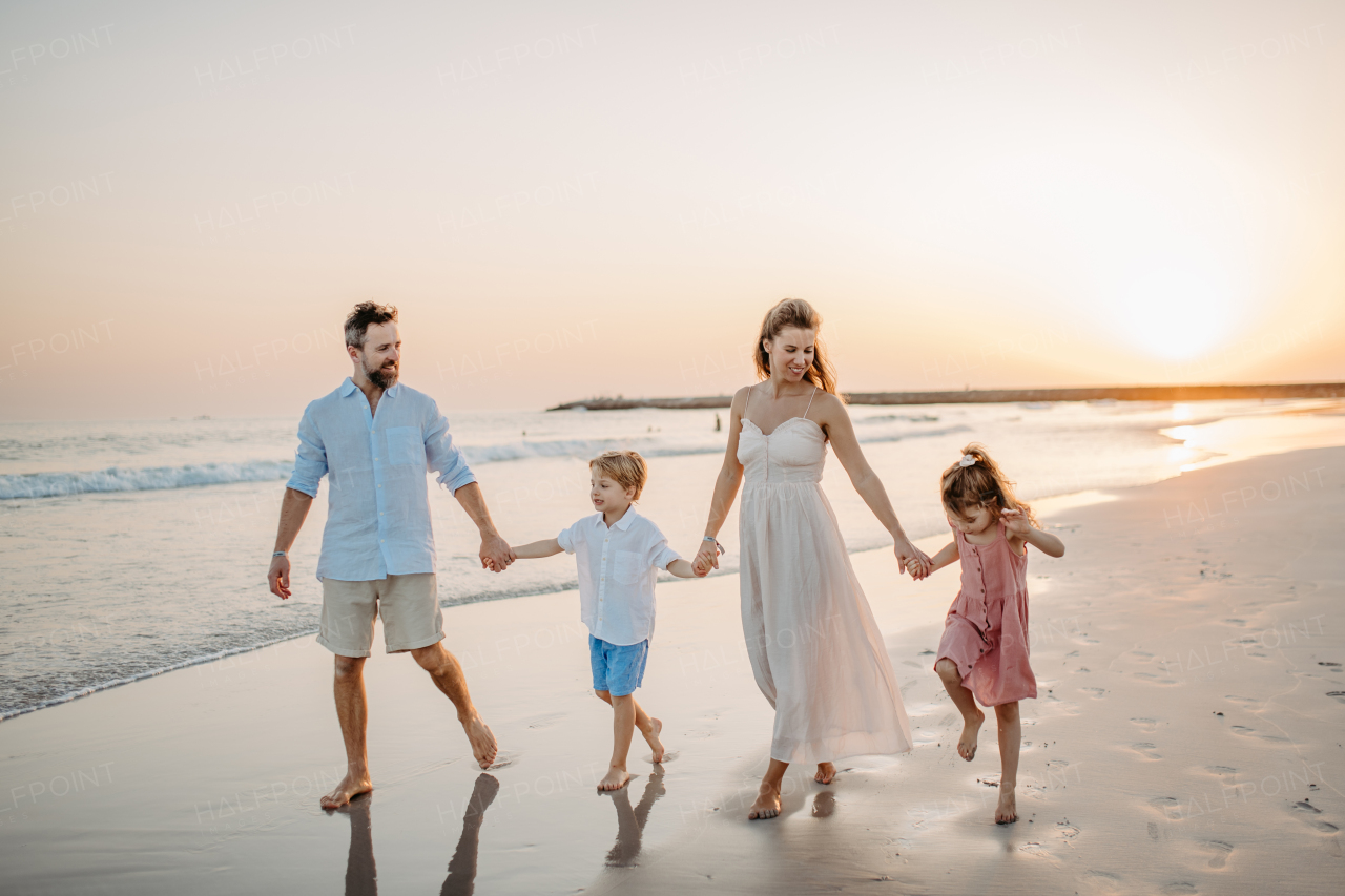 Happy family with little kids enjoying time at the sea in exotic country.