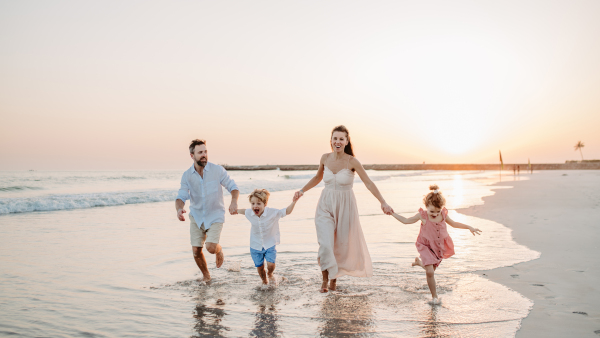 Happy family with little kids enjoying time at the sea in exotic country.