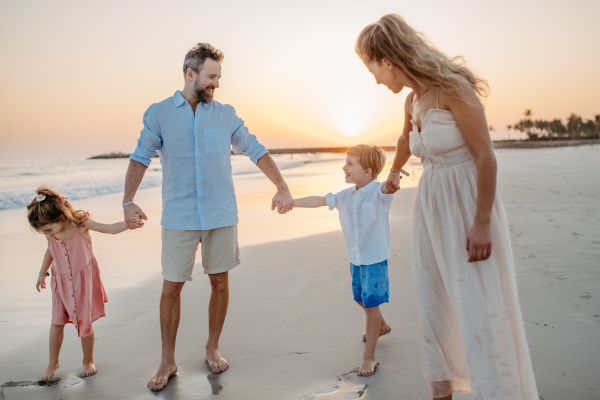 Happy family with little kids enjoying time at the sea in exotic country.