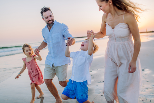 Happy family with little kids enjoying time at the sea in exotic country.