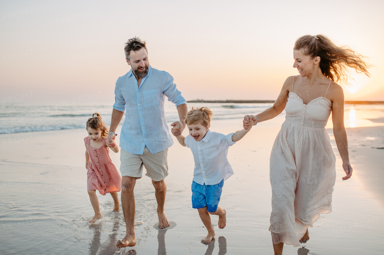 Happy family with little kids enjoying time at the sea in exotic country.