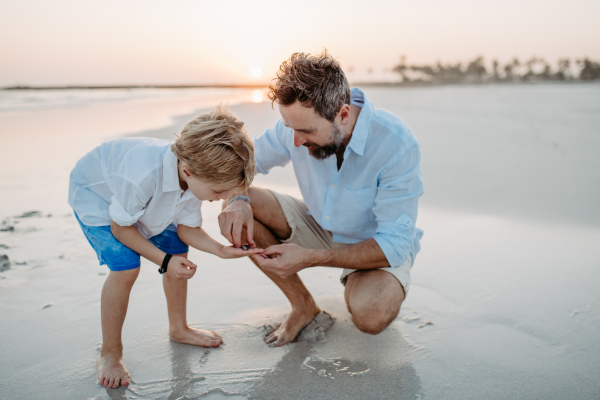 Father with his son enjoying together time at the sea.