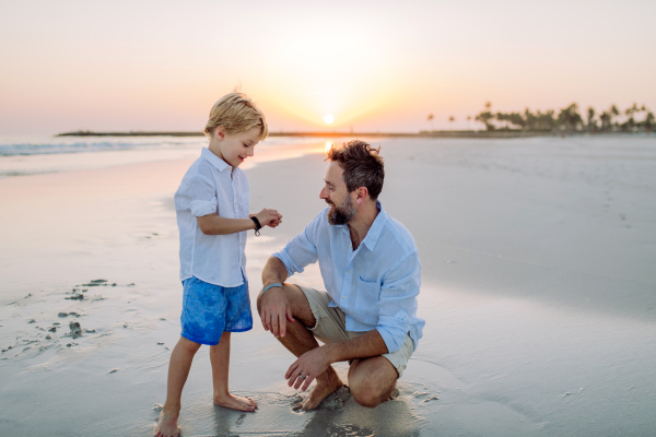 Father with his son enjoying together time at the sea.