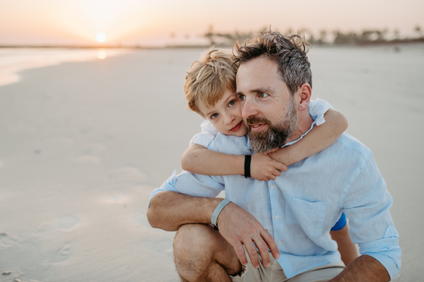 Father with his son enjoying together time at the sea.