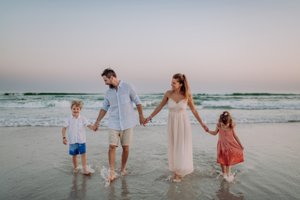 Happy family with little kids enjoying time at the sea in exotic country.