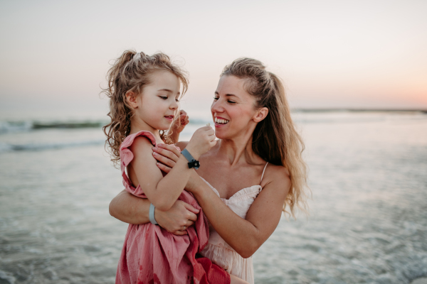 Mother enjoying together time with her daughter at the sea.