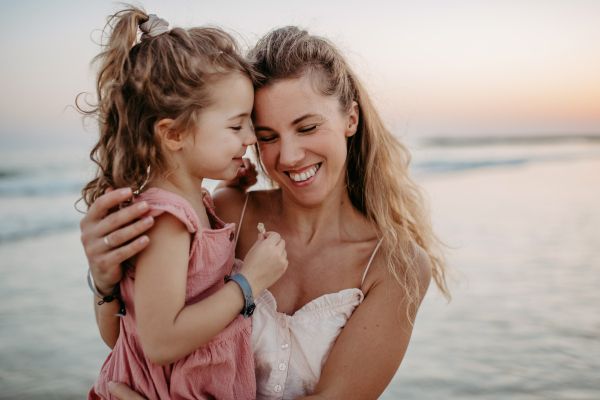 Mother enjoying together time with her daughter at the sea.