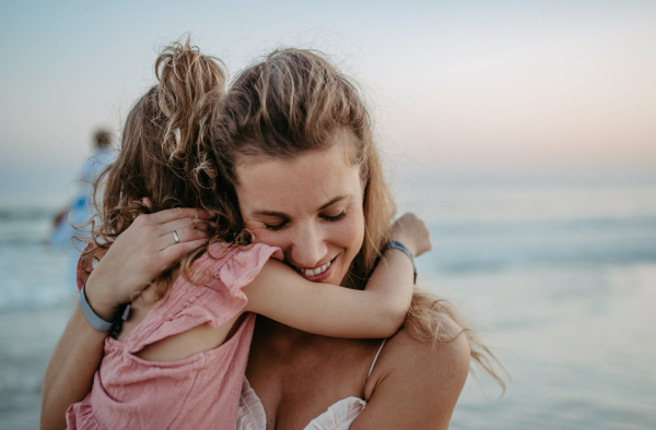 Mother enjoying together time with her daughter at the sea.