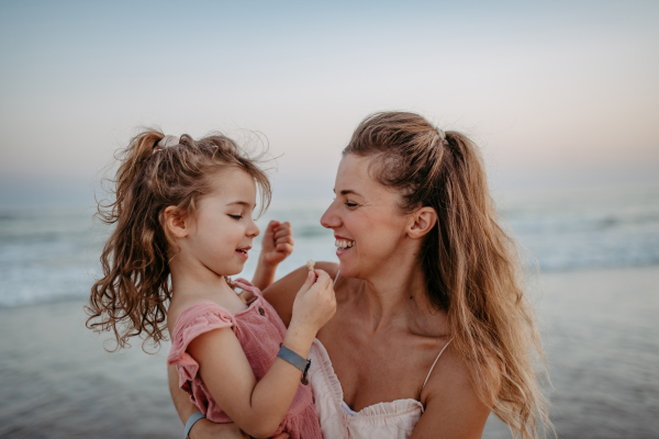 Mother enjoying together time with her daughter at the sea.